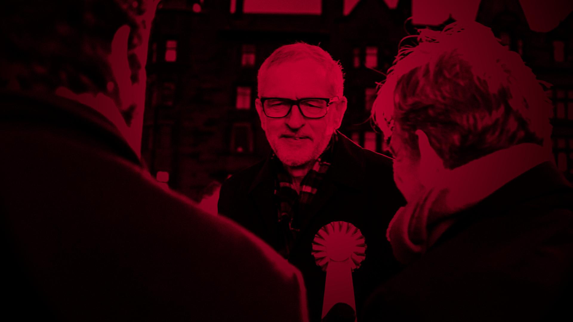 Jeremy Corbyn, the Labour Leader talking to two people